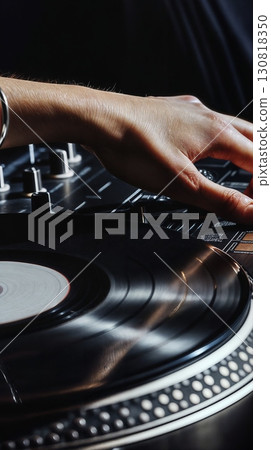 DJ hand adjusting vinyl record turntable dark music studio equipment DJ hand adjusting vinyl record turntable dark music studio equipment 130818350
