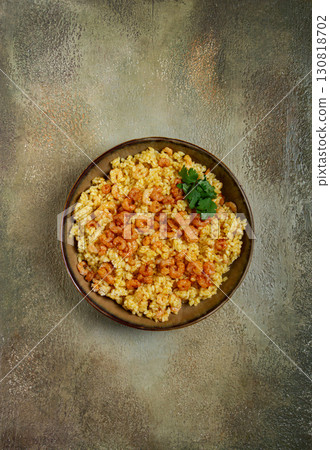 risotto with shrimp, in a bowl, on a textured surface, with a side dish of fresh coriander, homemade, no people, 130818702