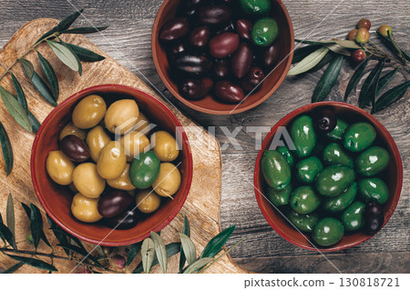 a mixture of olives, varieties of chalkidiki, Verdi giganti and Kalamata, in a bowl, top view, no people, a mixture of olives, varieties of chalkidiki, Verdi giganti and Kalamata, in a bowl, top view, no people, 130818721