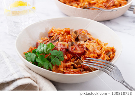 Bigos, Polish dish bigos, on the table, pan with stewed meat, with cabbage, chorizo sausages, mushrooms, homemade, without people, 130818738