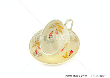 A Vintage Teacup and Saucer with a Floral Pattern 130818850