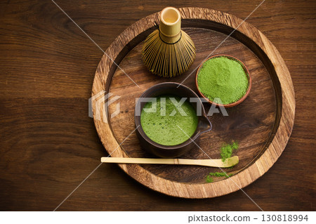 Traditional Matcha Preparation. Close-up of matcha tea in a bowl with a whisk and powder 130818994