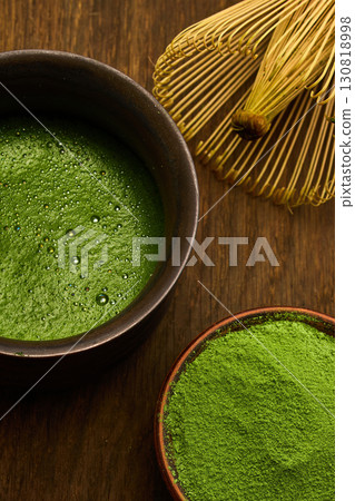 Matcha Tea and Whisk. A serene setup of matcha tea 130818998