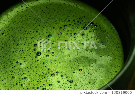 Vibrant Matcha Foam. Close-up of freshly whisked matcha with a frothy Vibrant Matcha Foam. Close-up of freshly whisked matcha with a frothy 130819000