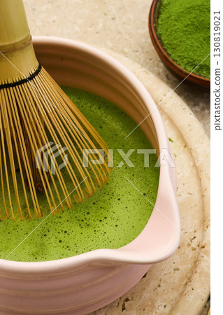 Matcha Tea Ceremony. A close-up of a traditional bamboo whisk in a bowl 130819021