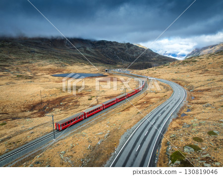 Aerial view of red train, river in mountains, road, orange forest Aerial view of red train, river in mountains, road, orange forest 130819046