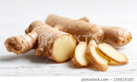 Fresh ginger root with sliced pieces on a rustic wooden background 130819105