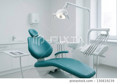 Modern dental office featuring a clean and comfortable examination chair with essential dental tools arranged neatly for patient care 130819239