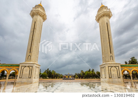 Two minarets tower of mausoleum of Habib Bourguiba on a cloudy day with decorated marble courtyard, Monastir, Tunisia 130819402