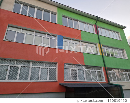 Facade of school building with windows and many-coloured wall Facade of school building with windows and many-coloured wall 130819430
