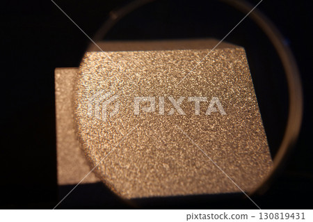 Sample of aluminum under magnifying glass with small grains,that froze very fast Sample of aluminum under magnifying glass with small grains,that froze very fast 130819431
