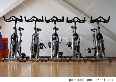 Five exercise bicycles in the gym. Cardio training. Exercise bikes without people 130819445