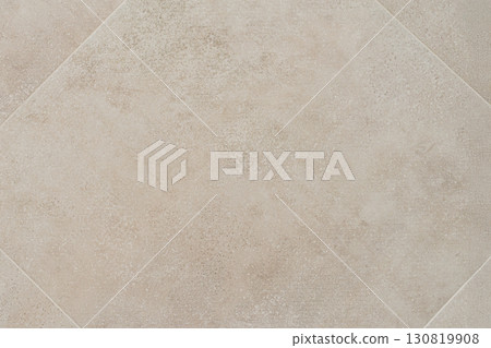 Beige ceramic tile with subtle concrete texture, captured top-down showing clean grout lines and modern design. Concept of tile background, ceramic texture, construction material and flooring 130819908