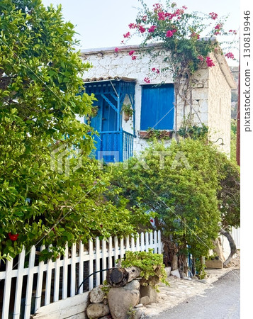 Picturesque white house with bougainvillea flowers. Traditional old Mediterranean house. 130819946