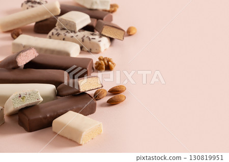 Tasty whey protein bars with various chocolate coatings and sprinkles on pink background. Close up. Copy space. 130819951