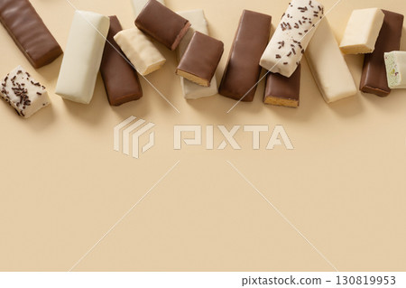 Different whey protein bars with various coatings and sprinkles scoop of protein powder on beige background. Healthy fitness nutrition. View from above. Copy space 130819953