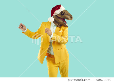 Freaky man with dinosaur head wearing santa hat having fun, happy and dancing at christmas party. Freaky man with dinosaur head wearing santa hat having fun, happy and dancing at christmas party. 130820040