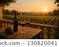 Wine bottle and glasses on wooden table overlooking vineyard at sunset with beautiful landscape 130820041