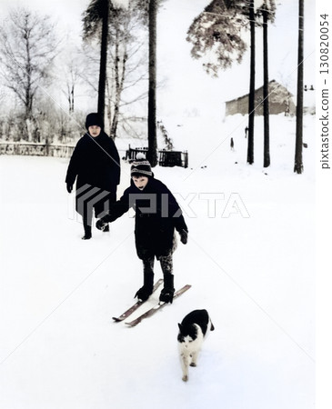 Vintage portrait of happy mother and son. Mother teaches son to ski. Snowy winter. Retro photo 1971. USSR. 130820054