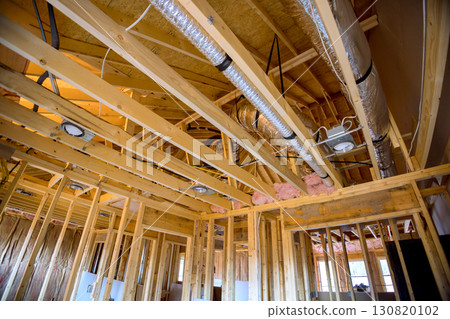 Workers are installing ductwork, completing framing in residential construction project. Workers are installing ductwork, completing framing in residential construction project. 130820102