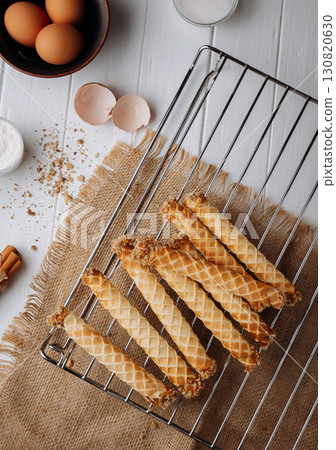 Traditional homemade waffle rolls with ingredients on rustic kitchen background Traditional homemade waffle rolls with ingredients on rustic kitchen background 130820630