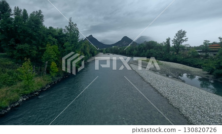 Drac river near Grenoble, France in September, with low water level and exposed gravel banks, surrounded by Alps mountains and green forest landscape Drac river near Grenoble, France in September, with low water level and exposed gravel banks, surrounded by Alps mountains and green forest landscape 130820726