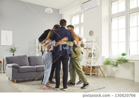 Group of young happy friends meeting at home and hugging enjoying spending time together. 130820766