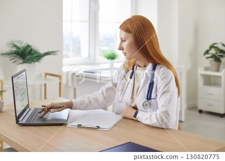 Doctor Or Nurse Working On A Laptop In A Medical Office Doctor Or Nurse Working On A Laptop In A Medical Office 130820775
