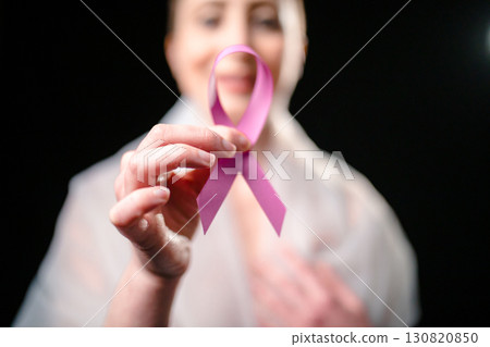 Happy Woman Holding The Pink Ribbon For Cancer Awareness  130820850