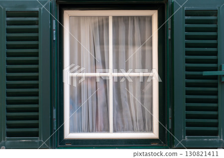 Window With Closed Shutters and Sheer Curtains in Window With Closed Shutters and Sheer Curtains in 130821411