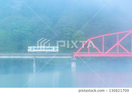 Kitakami Line: Kiha 100 running across Lake Kinshu in the morning mist - Second Waga River Bridge 130821709