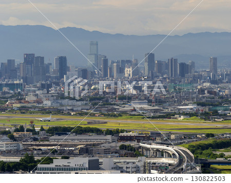 Airplane taking off from Itami Airport and the Osaka cityscape Airplane taking off from Itami Airport and the Osaka cityscape 130822503