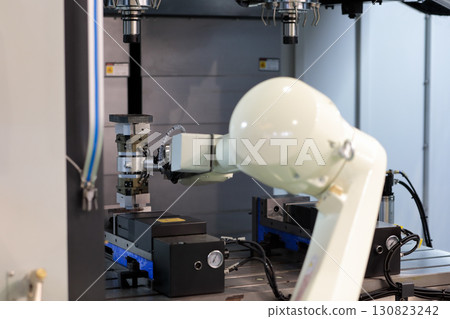 robot assistant loading parts into machine 130823242