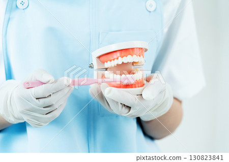 Dental hygienist giving tooth brushing instructions Dental hygienist giving tooth brushing instructions 130823841