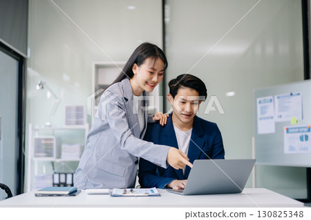 Portrait of success business people working together in office. Couple teamwork startup concept Portrait of success business people working together in office. Couple teamwork startup concept 130825348