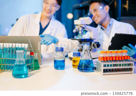 Scientist team meeting and writing analysis results in the laboratory study 130825776