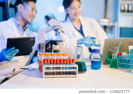 Scientist team meeting and writing analysis results in the laboratory study Scientist team meeting and writing analysis results in the laboratory study 130825777