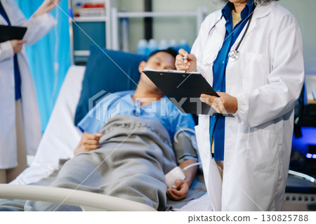 Hospital Ward Male and Male Professional Asian Doctors Talk with a Patient, Give Health Care Advice, Hospital Ward Male and Male Professional Asian Doctors Talk with a Patient, Give Health Care Advice, 130825788