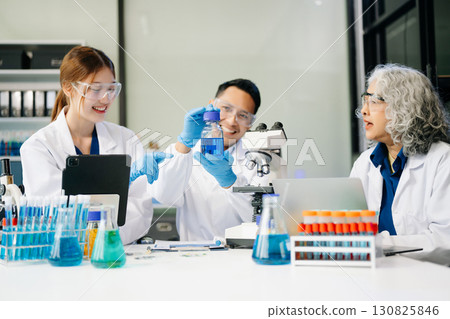 Dynamic science lab where a team of scientists collaborates on research, testing, and innovation 130825846