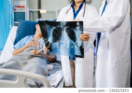 Hospital Ward Male and Male Professional Asian Doctors Talk with a Patient, Give Health Care Advice, Hospital Ward Male and Male Professional Asian Doctors Talk with a Patient, Give Health Care Advice, 130825853