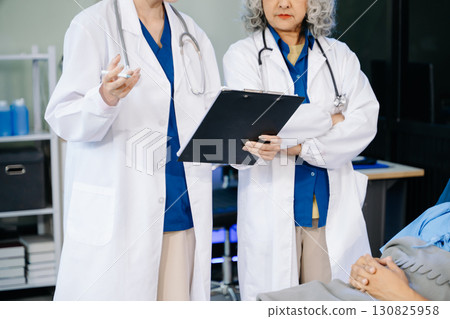 Hospital Ward Male and Male Professional Asian Doctors Talk with a Patient, Give Health Care Advice, Hospital Ward Male and Male Professional Asian Doctors Talk with a Patient, Give Health Care Advice, 130825958