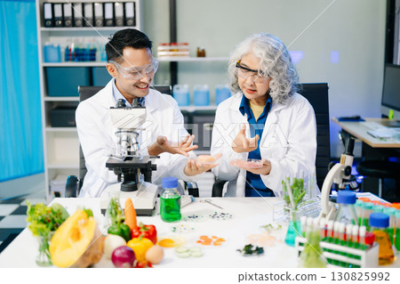 Food scientists in lab coats, testing samples, and analyzing food safety and quality in a modern laboratory Food scientists in lab coats, testing samples, and analyzing food safety and quality in a modern laboratory 130825992
