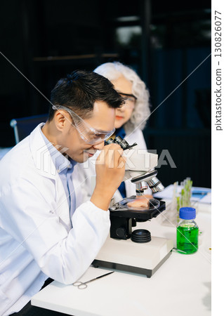 Food scientists in lab coats, testing samples, and analyzing food safety and quality in a modern laboratory 130826077