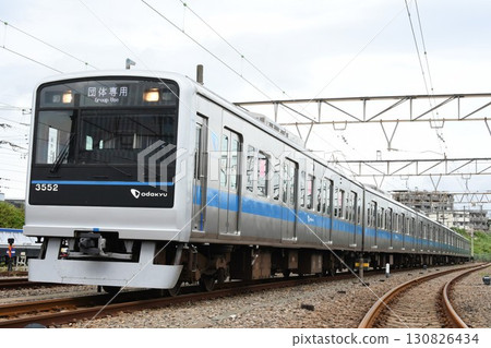 Odakyu Electric Railway 3000 series train with a group-only sign parked at the depot Odakyu Electric Railway 3000 series train with a group-only sign parked at the depot 130826434