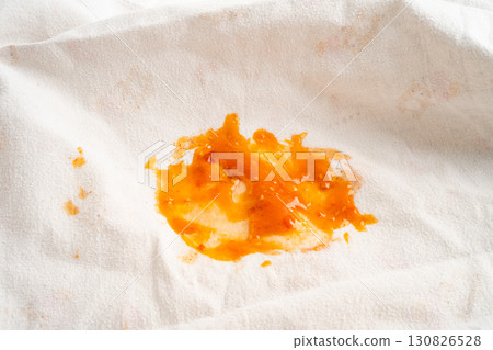Dirty tomato sauce stain or ketchup on cloth. 130826528