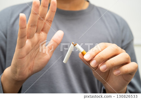 Quit smoking, Asian teenage man breaking destroy cigarette in hand. Quit smoking, Asian teenage man breaking destroy cigarette in hand. 130826533