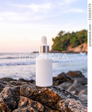 White Dropper Bottle on Coastal Rocks 130826579