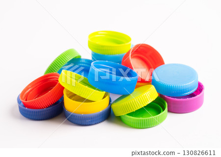 Plastic bottle colored screw caps for recycle waste on white background, container water lid. Plastic bottle colored screw caps for recycle waste on white background, container water lid. 130826611