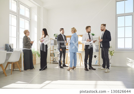 In modern office environment, several diverse groups of professionals interact during workday. In modern office environment, several diverse groups of professionals interact during workday. 130826644