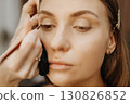 Applying eye makeup. Creating model image 130826852
